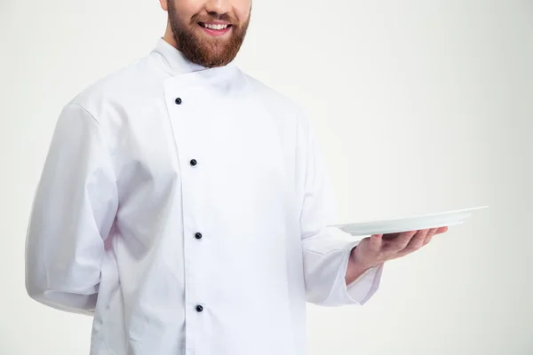 Happy male chef cook holding empty plate — Stock Photo, Image