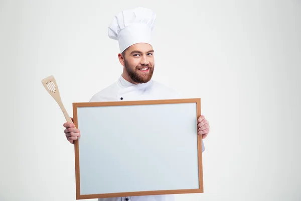 Sorrindo cozinheiro masculino chef segurando placa em branco — Fotografia de Stock