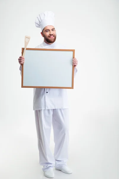 Smiling male chef cook holding blank — Stock Photo, Image