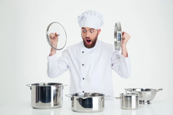 Male chef cook sitting at the table with dishes — Stock Photo, Image