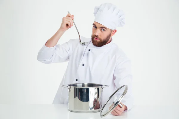 Handsome male chef cook tasting food — Stock Photo, Image