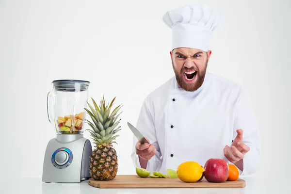 Chef cozinheiro sentado à mesa com frutas — Fotografia de Stock