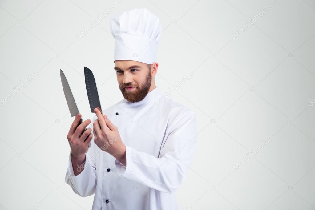 Chef cook holding and looking on knifes