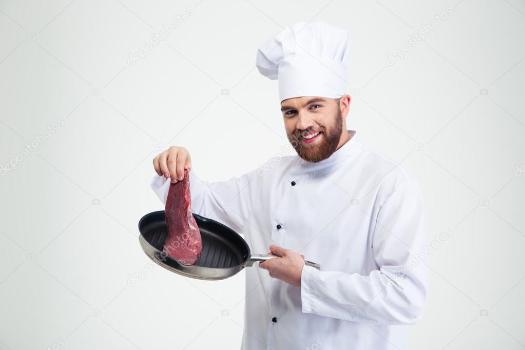 Smiling chef cook holding pan with fresh meat
