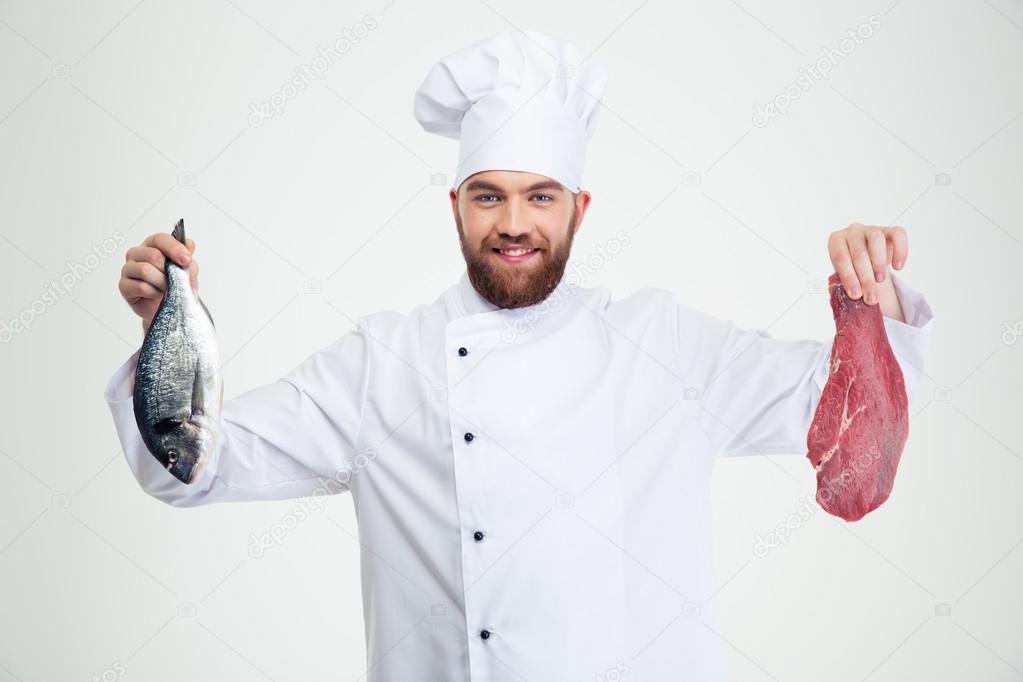 Male chef cook holding fresh fish and meat