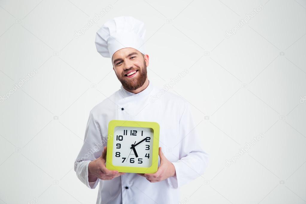 Laughing male chef cook holding wall clock