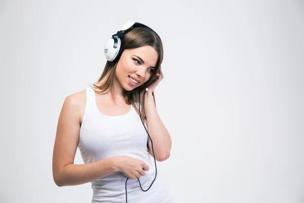 Happy girl listening the music in headphones — Stock Photo, Image