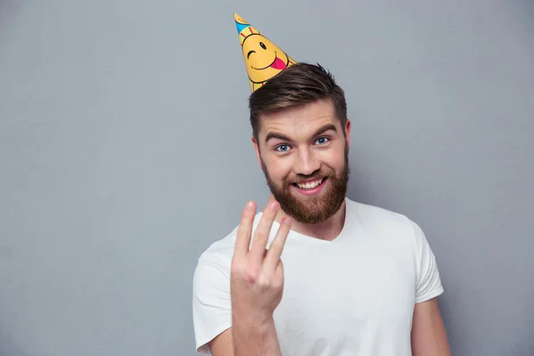 Man with birthday hat showing three fingers — Stock Photo, Image