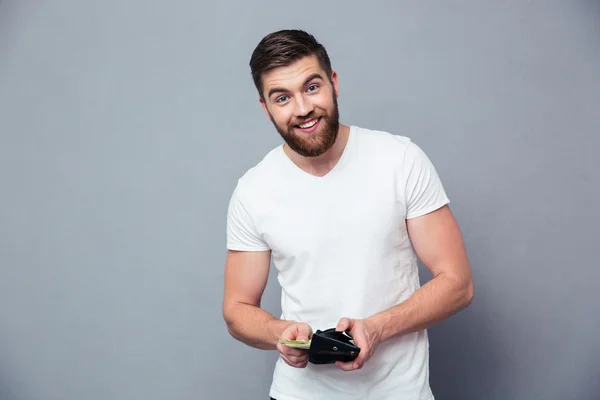 Portrait of a happy man holding wallet with money — Stock Photo, Image