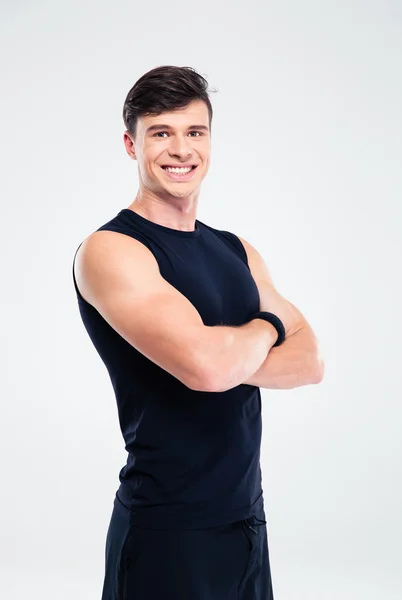 Smiling sports man standing with arms folded — Stock Photo, Image