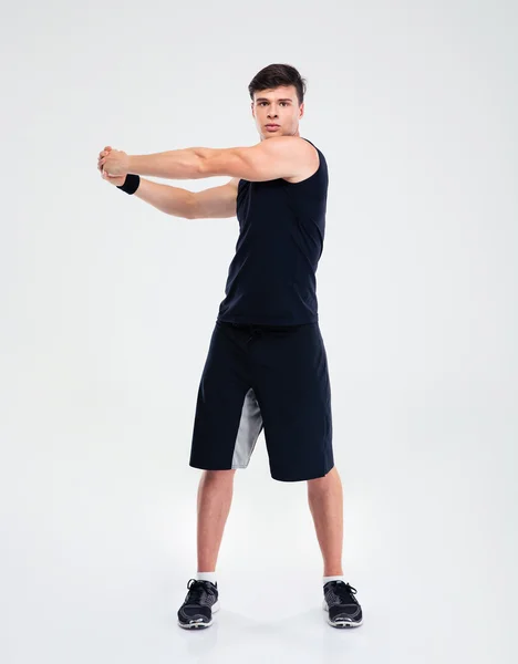 Full length portrait of a fitness man stretching hands — Stock Photo, Image