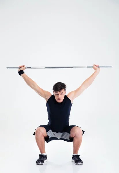 Hombre de fitness en cuclillas con barra — Foto de Stock