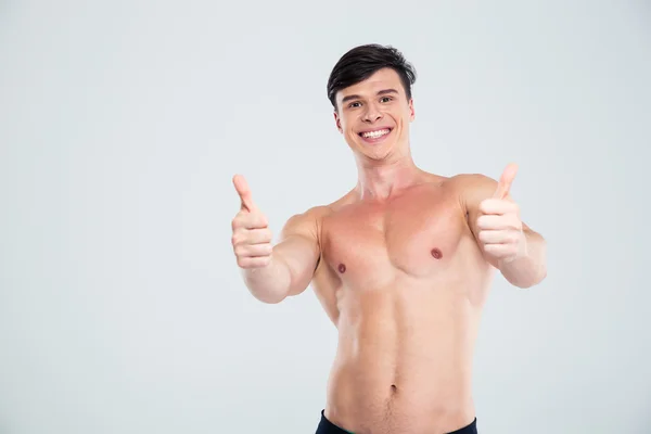 Smiling athletic man showing thumbs up — Stock Photo, Image