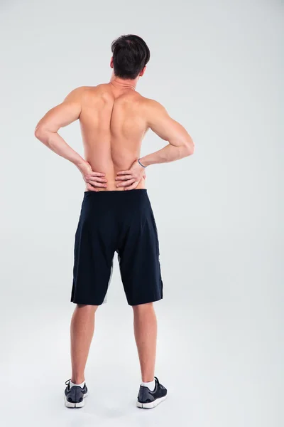 Homem atlético com dor nas costas — Fotografia de Stock