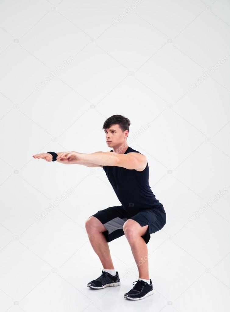 Fitness man doing squatting exercises