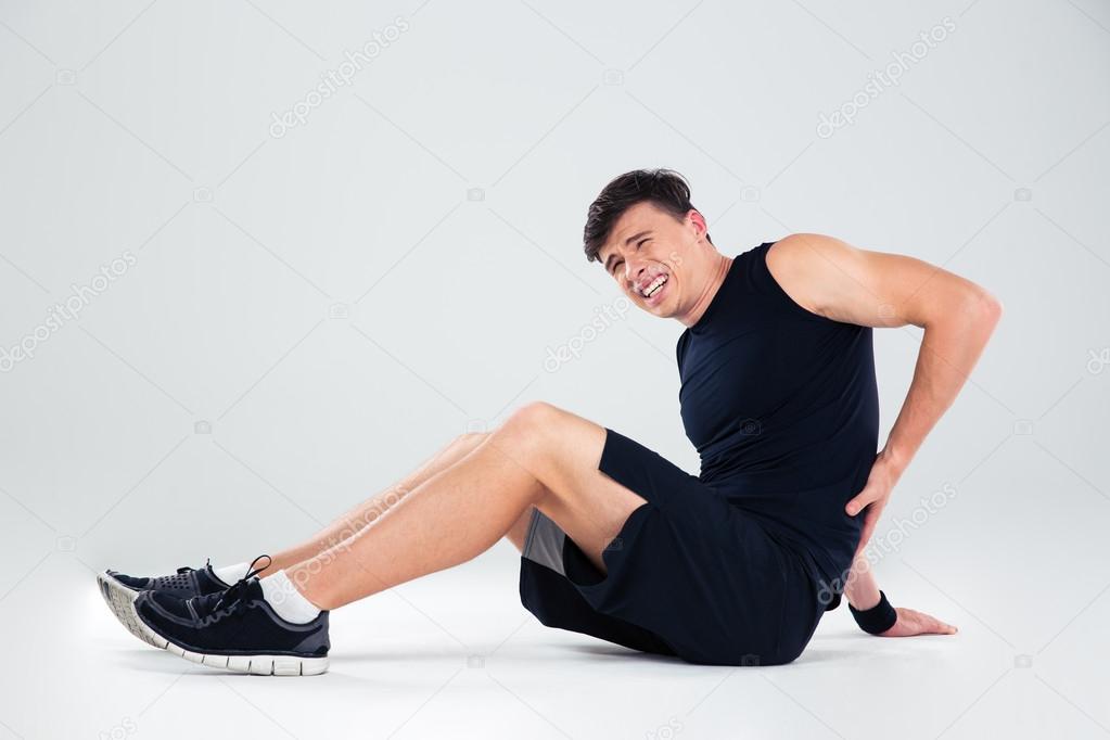 Portrait of a fitness man having back pain