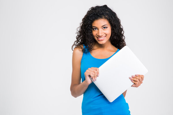 Smiling afro american woman holding laptop