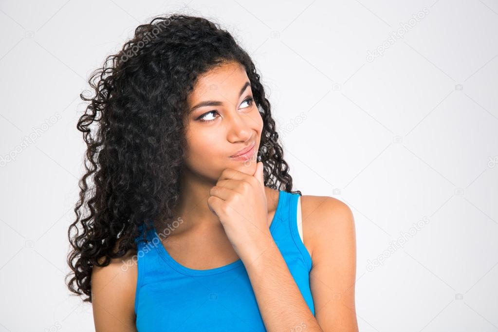 Happy thoughtful afro american woman looking up