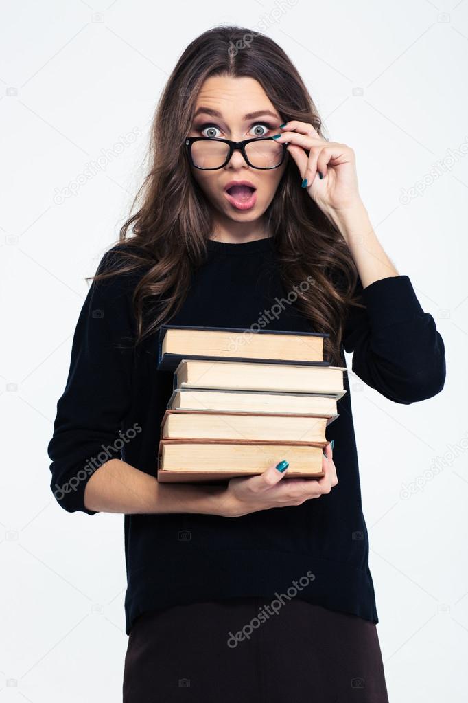 Cheerful woman in glasses holding books