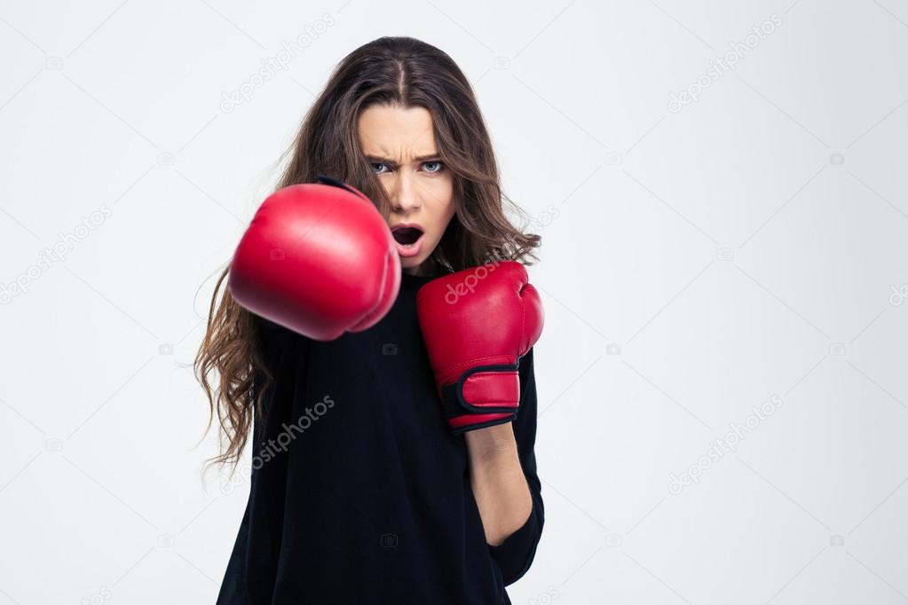Woman in boxing gloves hitting at camer