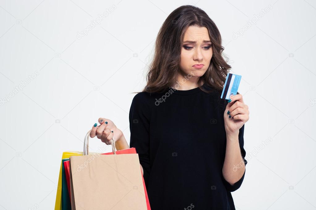 Sad woman holding shopping bags and bank