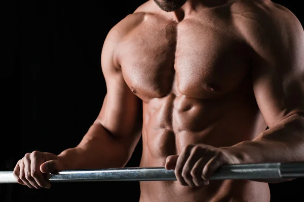 Muscular male body with barbell — Stock Photo, Image