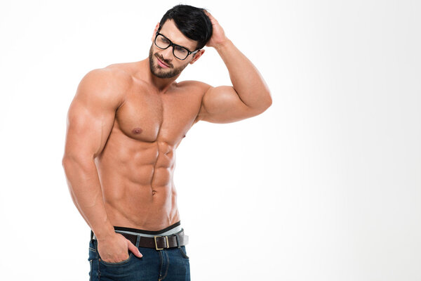 Thoughtful muscular man in glasses looking away