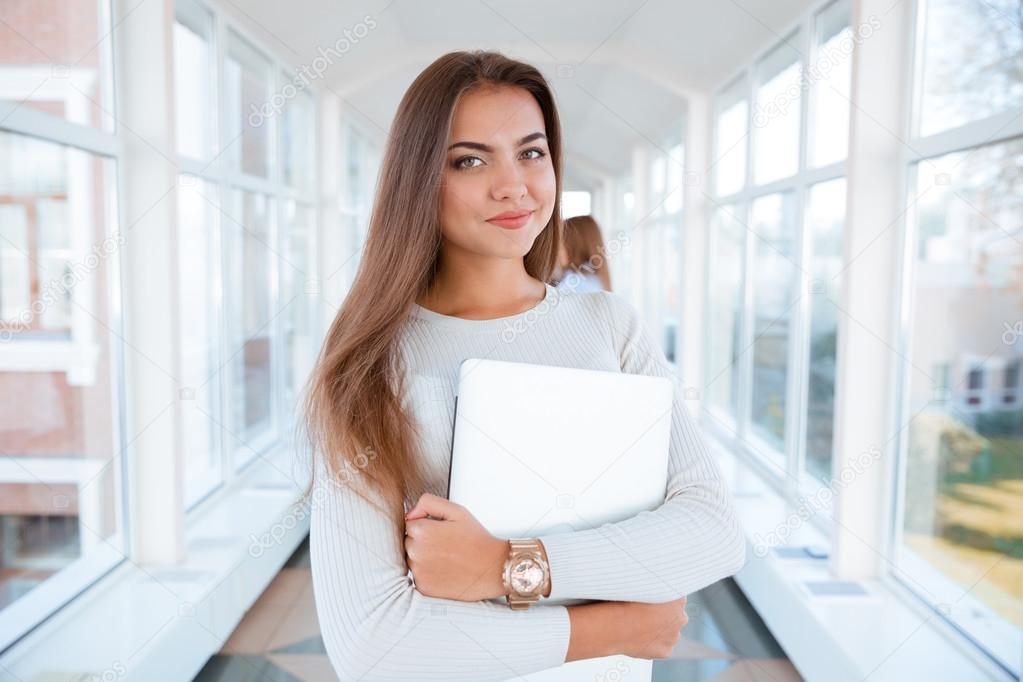 Beautiful woman standing in university hall