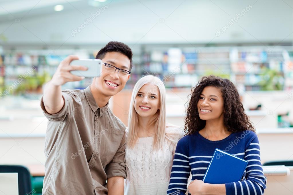 Students making selfie photo on smartphone