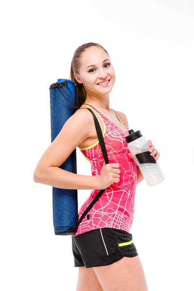 Lächelnde Fitness-Frau mit Shaker und Yogamatte — Stockfoto