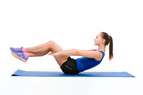 Young sportswoman in sportwear doing exercises — Stock Photo, Image