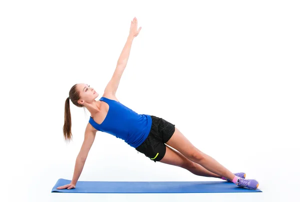 Joven deportista en ropa deportiva haciendo yoga — Foto de Stock