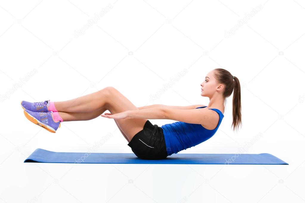 Young sportswoman in sportwear doing exercises