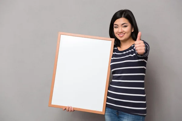 Woman holding blank board and showing thumb up — Stock Photo, Image