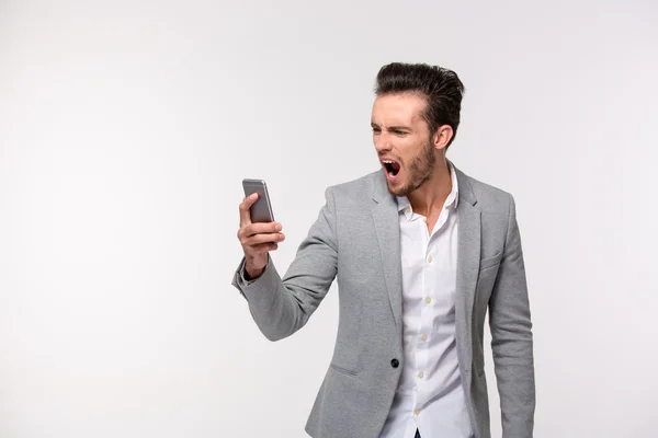 Businessman screaming on smartphone — Stock Photo, Image
