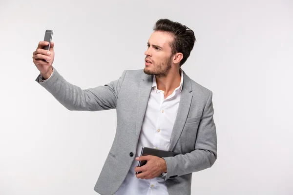 Businessman making selfie photo on smartphone — Stock Photo, Image