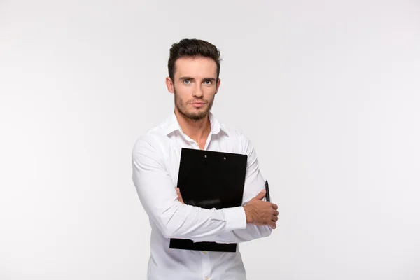 Handsome businessman holding clipboard — Stock Photo, Image