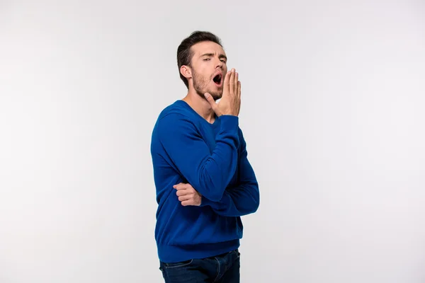 Portrait of a young man yawning — Stock Photo, Image