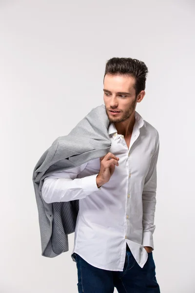 Handsome man holding jacket on shoulder — Stock Photo, Image