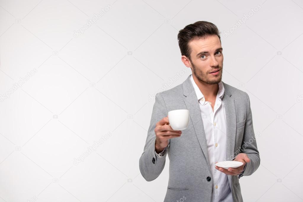 Happy businessman drinking coffee