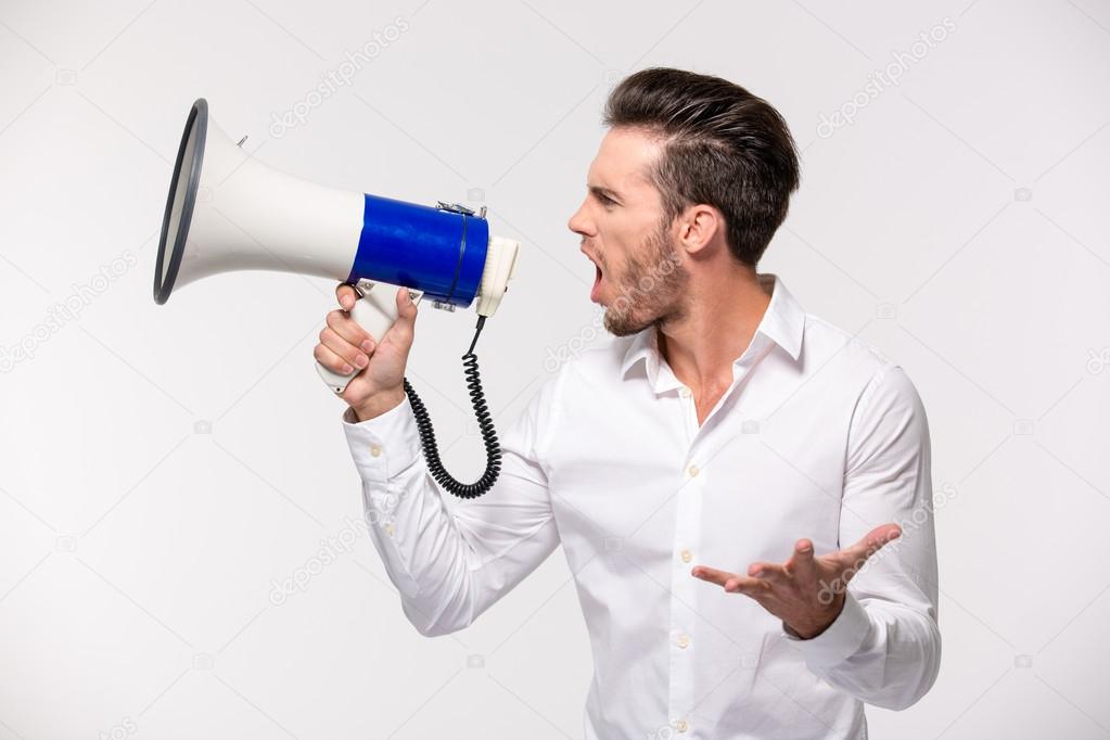 Portrait of a man yelling in megaphone