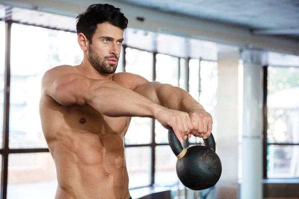 Muscular man workout with kettle ball — Stock Photo, Image