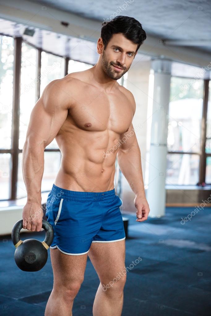 Fitness man holding kettle ball