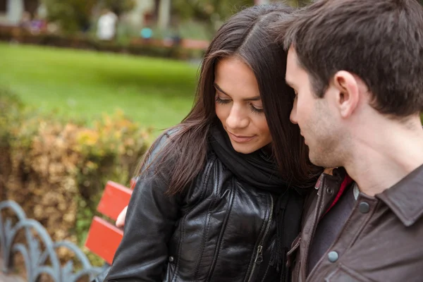 Couple sitting on the bench outdoors — Stock Photo, Image