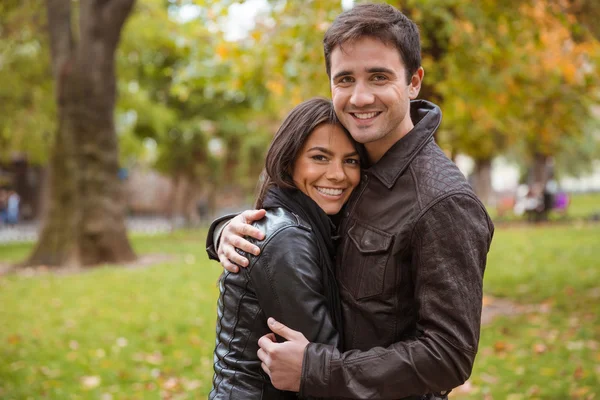 Happy couple hugging outdoors in park — Stock Photo, Image