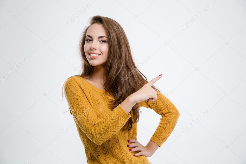 Smiling woman pointing finger away