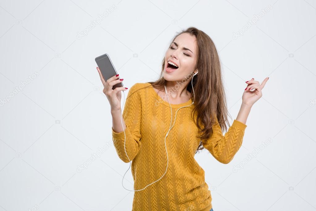 Happy woman listening music in headphones