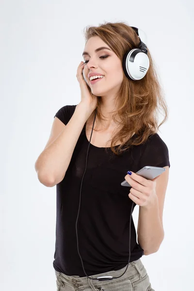 Happy woman listening the music in headphones — Stock Photo, Image