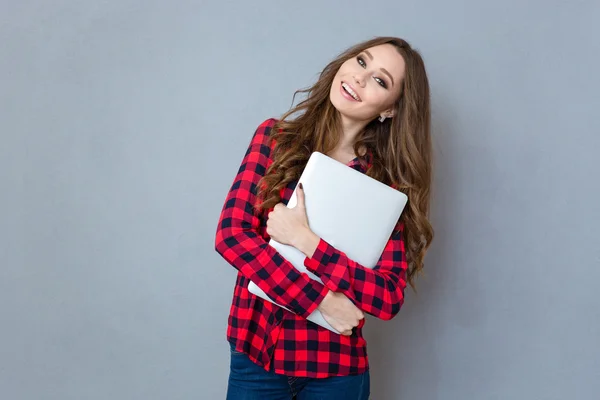Porträtt av leende flicka kramar laptop — Stockfoto