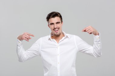 Smiling confident man pointing on himself clipart